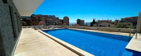 View of the outdoor swimming pool and surrounding buildings. - image 19