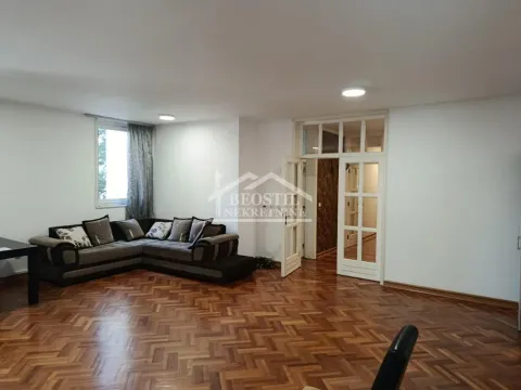 Living room with a corner sofa and wooden parquet flooring. - image 2