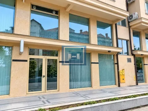 View of the building exterior with large glass surfaces and an entrance door. - image 3