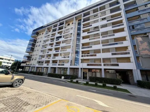 Exterior of a multi-family residential building with balconies and street parking. - image 14