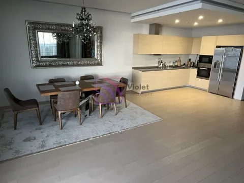 Open space with a dining area and a modern kitchen. - image 7
