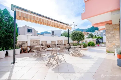 Spacious tiled terrace with outdoor seating and an awning. - image 4