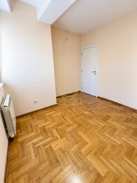 Empty room with parquet flooring and a white door. - image 5