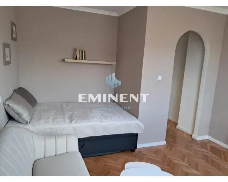 Furnished bedroom with a bed and a wall shelf. - image 7
