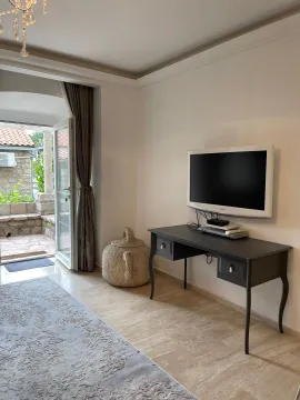 Living room with a desk, television, and access to the terrace. - image 4