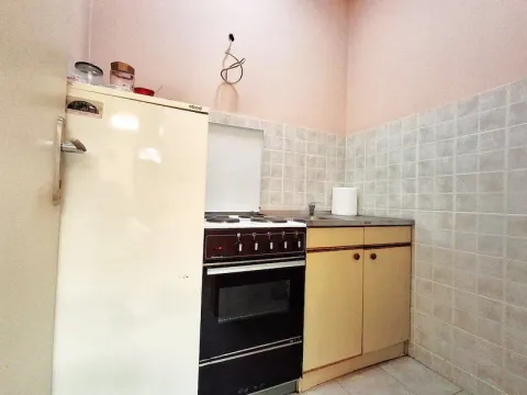 Small kitchen with a stove, refrigerator, and sink. - image 4
