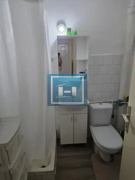 Smaller bathroom with a shower cabin, washbasin, and toilet. - image 3