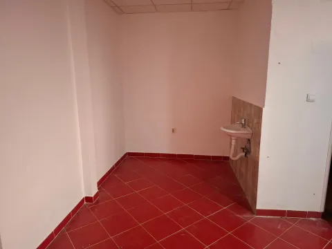Small bathroom with a sink and red ceramic floor tiles. - image 6