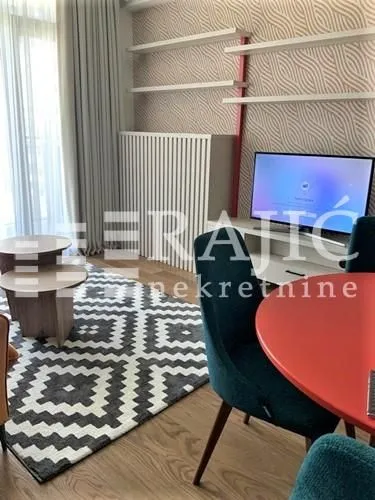 Living room with furniture, television, and dining table.