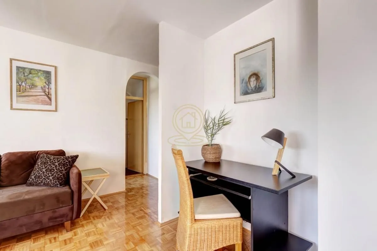 Living room with a desk and a sofa.