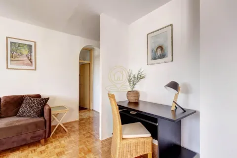 Living room with a desk and a sofa. - image 13