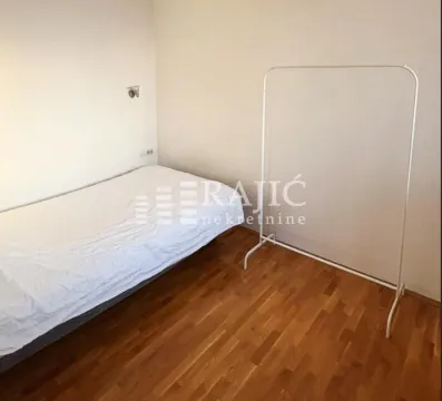 Empty bedroom with a bed and a clothes rack. - image 8