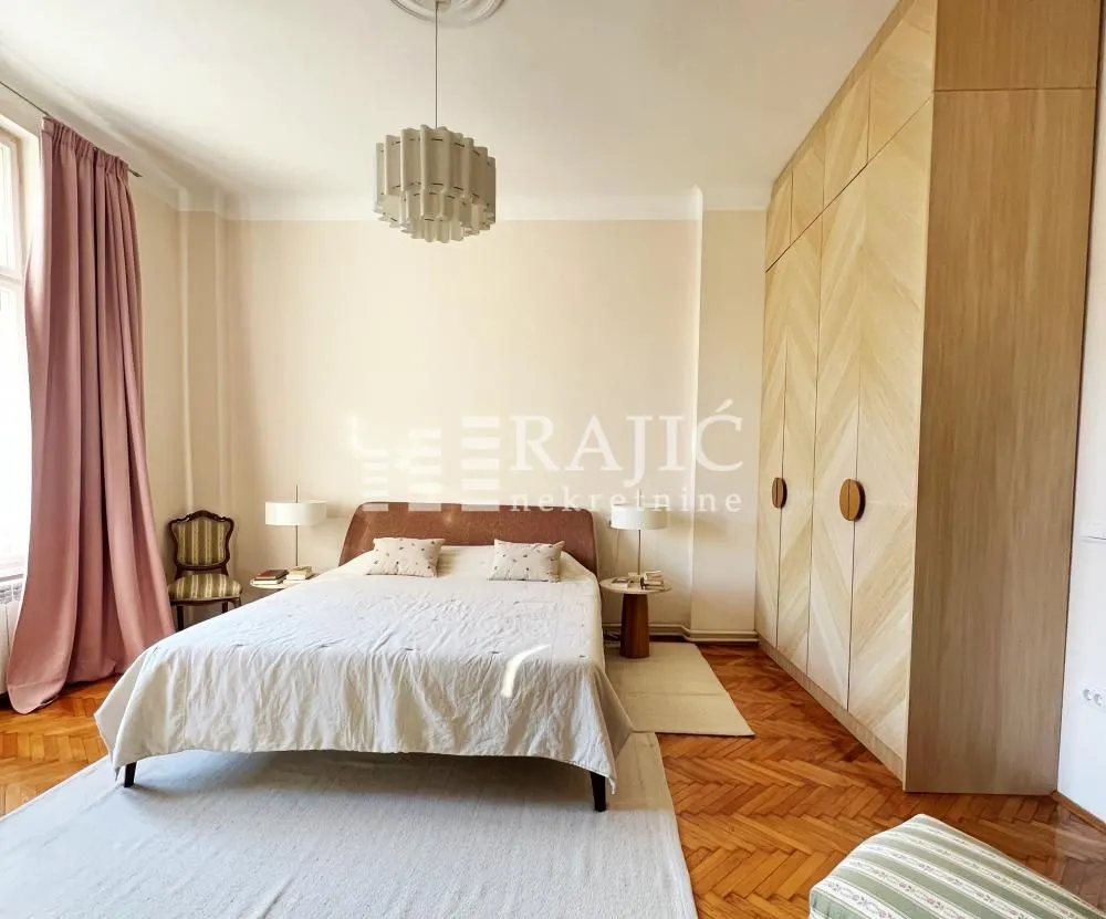 Spacious bedroom with a double bed and a large fitted wardrobe.
