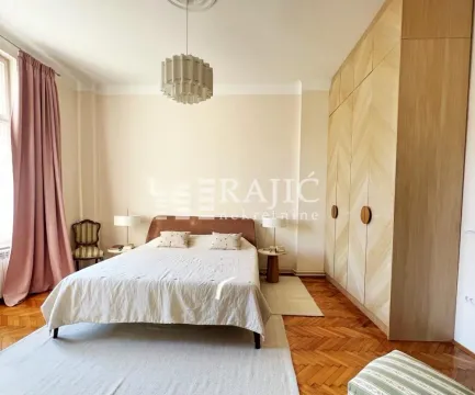 Spacious bedroom with a double bed and a large fitted wardrobe. - image 5