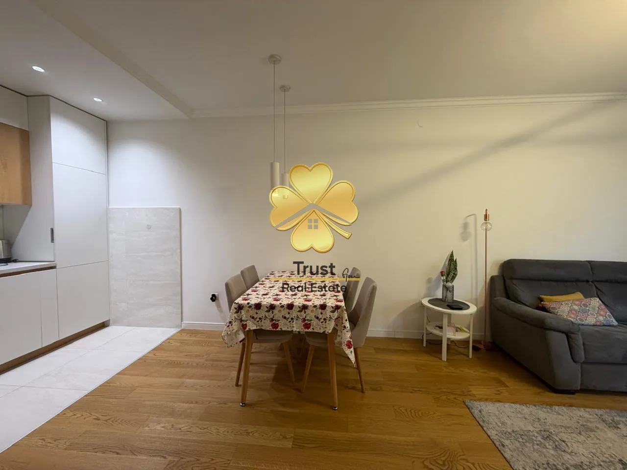 Living room with a dining area and kitchen in the background.