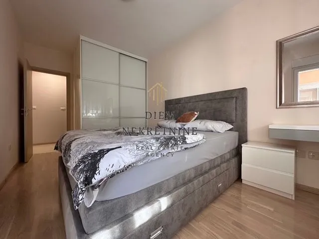 Bedroom with a double bed, wardrobe, and mirror.