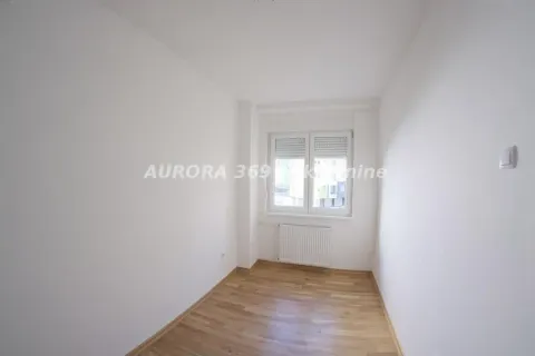 Empty room with white walls, hardwood flooring, and a single window. - image 4