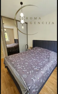 Tidy bedroom with a double bed and a mirrored wardrobe. - image 6