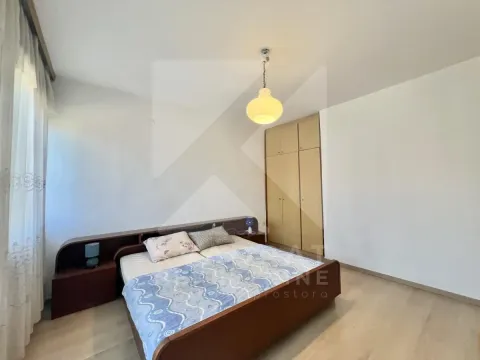 Bedroom with a double bed, built-in wardrobe, and wooden flooring. - image 6