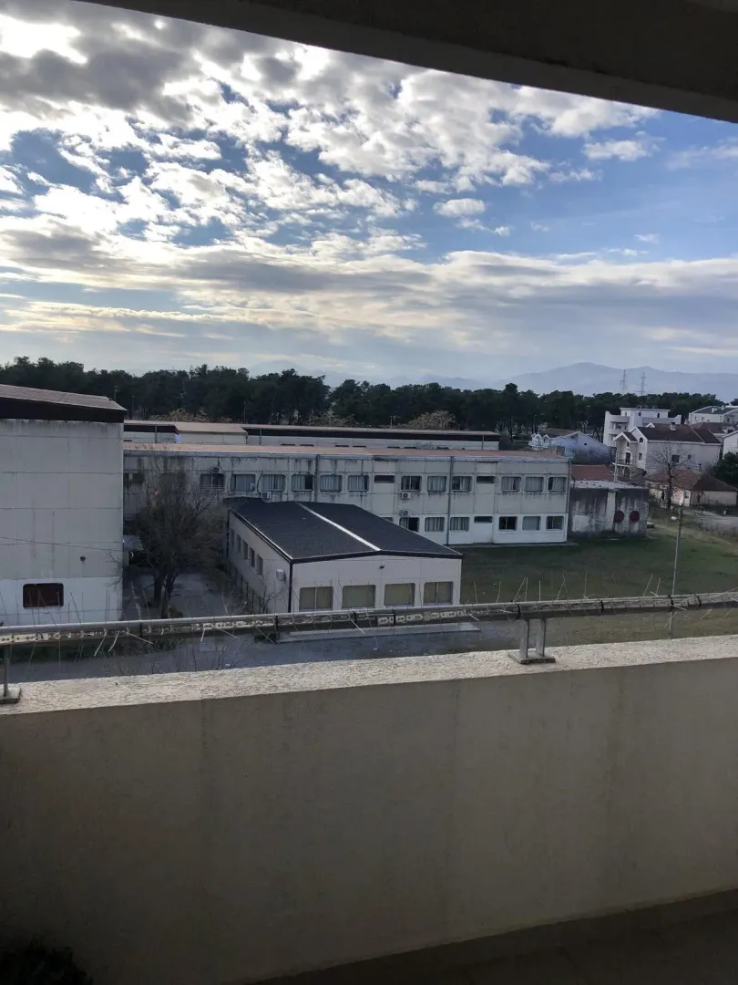 View from the balcony of the surrounding buildings and sky.