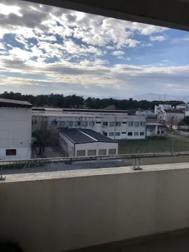 View from the balcony of the surrounding buildings and sky. - image 9