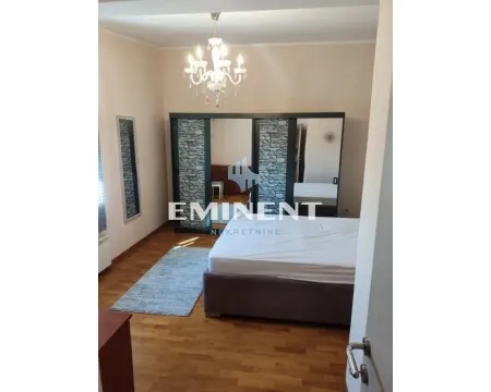 Furnished bedroom with a double bed, large wardrobe, and chandelier. - image 12