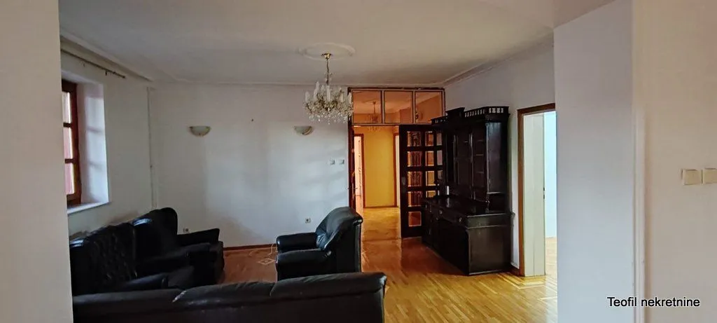 Living room with seating furniture and wooden flooring.