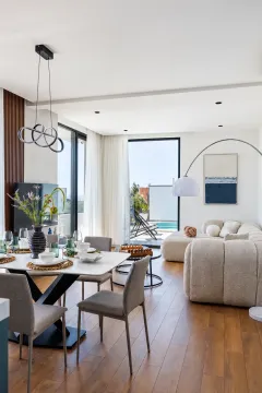 Modern living room with a dining area and access to the terrace with a pool. - image 7