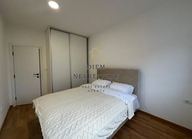 Furnished bedroom with a double bed and built-in wardrobe.