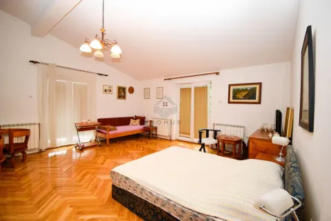 Spacious bedroom with a double bed, wooden parquet flooring, and access to the terrace. - image 17