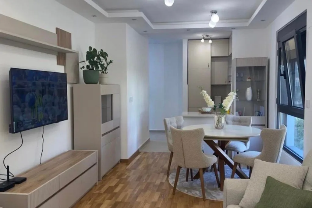 Living room with dining area and kitchen in the background.