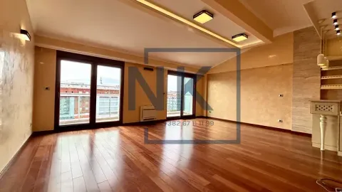 Spacious living room with wooden flooring and access to the terrace. - image 2