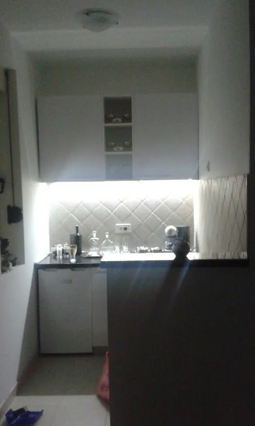 Small kitchen with white cabinets and a countertop.