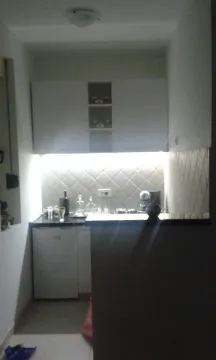 Small kitchen with white cabinets and a countertop. - image 20