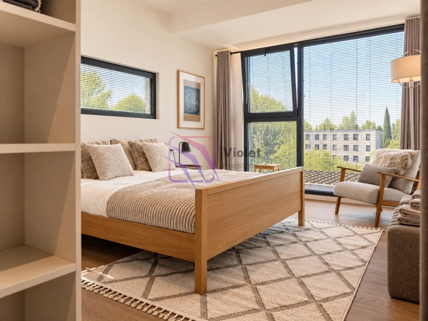 Spacious bedroom with a double bed, armchair, and large windows.