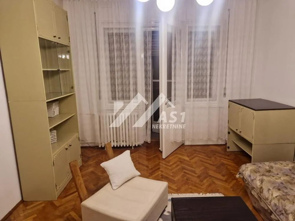 Living room with furniture, parquet flooring, and access to the terrace.