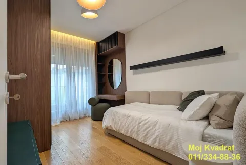Modern bedroom with a bed, wooden furniture, and built-in wardrobe. - image 11