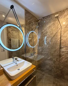 Modern bathroom with a sink and a glass shower cabin. - image 12