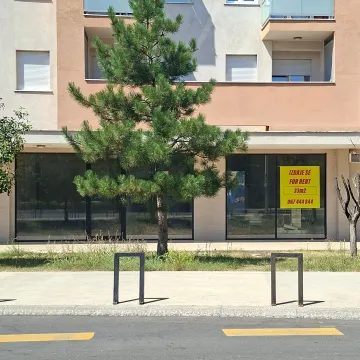 Facade of the ground-floor commercial space in a residential building with a for rent sign. - image 2
