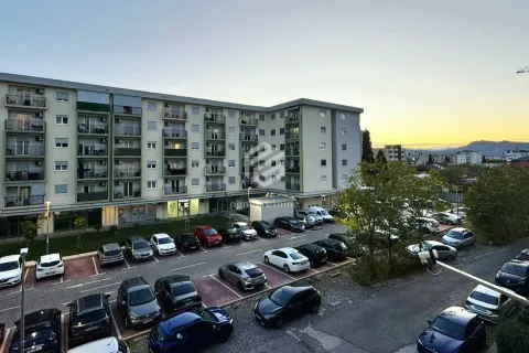 View of the residential building and parking lot in front of the property. - image 3