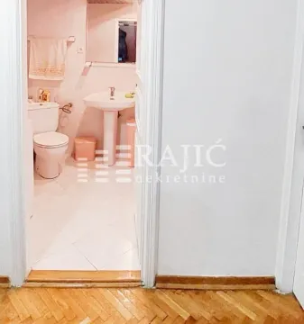 View of the bathroom through an open door. - image 4