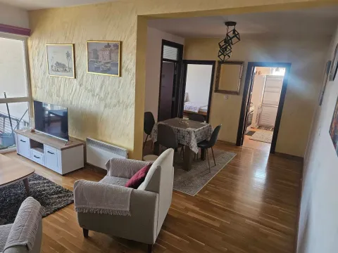 Spacious living room with a dining area and a view of the hallway. - image 2