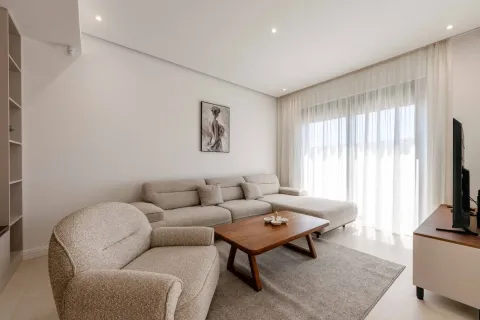 Living room with a sectional sofa, armchair, and wooden coffee table. - image 4