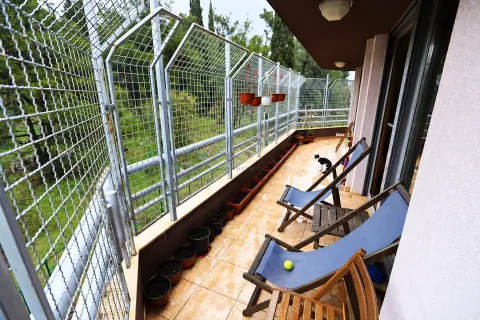 Dugačak prostrani balkon sa stolicama na sklapanje i zaštitnom ogradom. - image 20