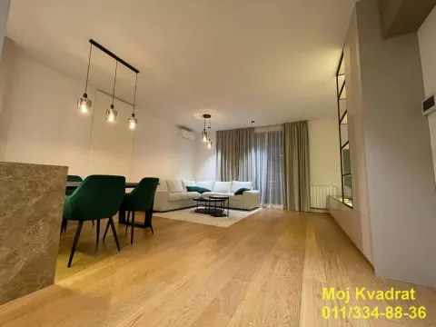 Spacious living room with dining area and hardwood flooring. - image 8