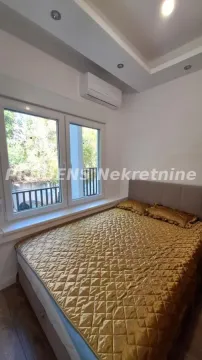 Spavaća soba sa bračnim krevetom, prozorom i klima uređajem. - image 5