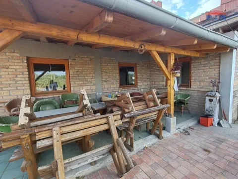 Covered terrace with a wooden canopy and outdoor seating furniture. - image 14