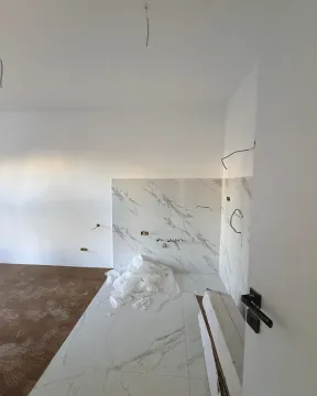 Newly renovated bathroom with marble tiles installed during final construction works. - image 4