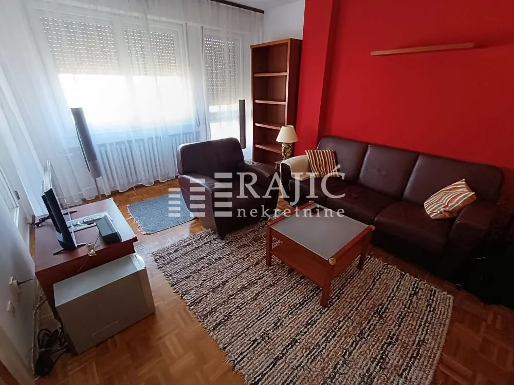 Living room with furniture and a red wall.