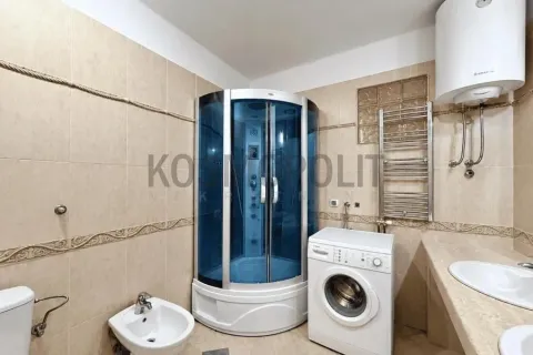 Bathroom equipped with a shower cabin, washbasin, bidet, washing machine, and water heater. - image 5